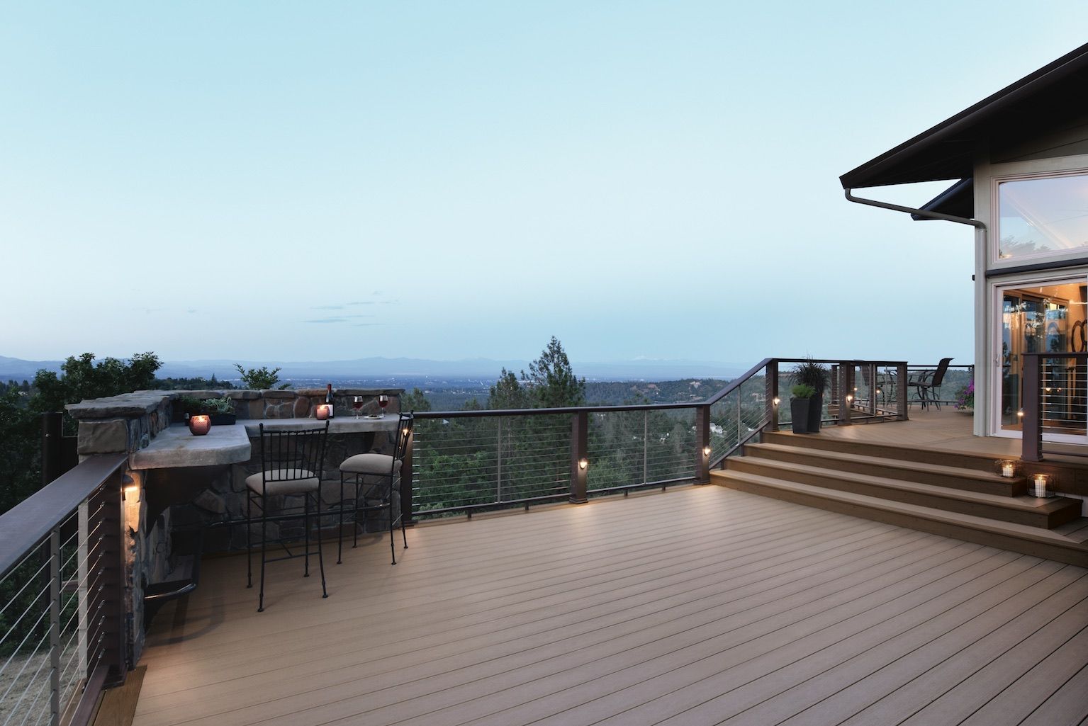 A large deck with a table and chairs on it