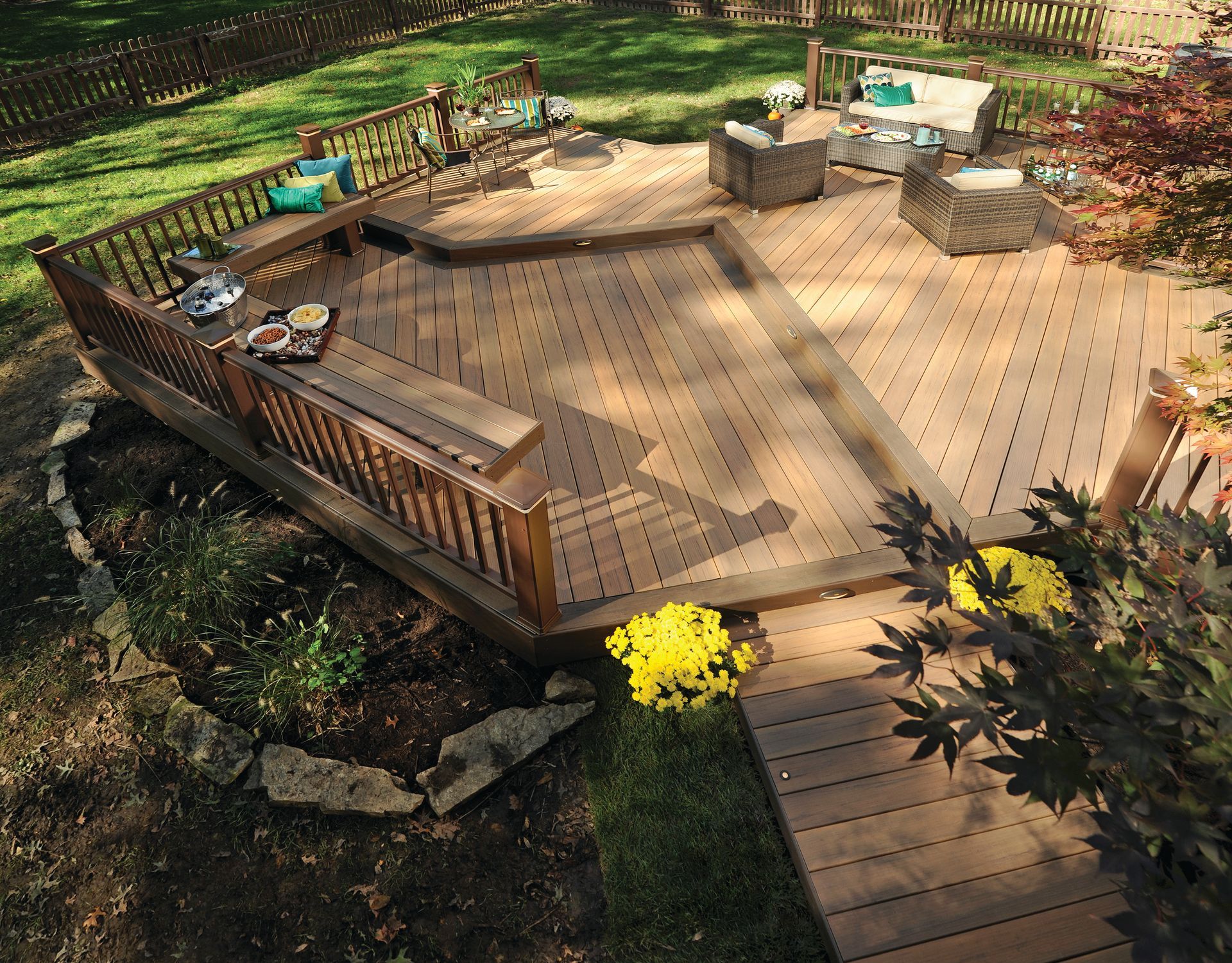 A wooden deck with a bench and chairs on it