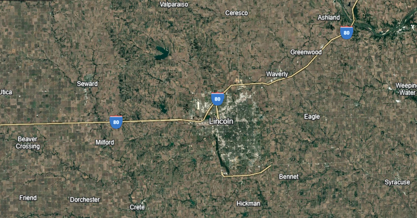 Aerial view of a city in Nebraska with Interstate 80 running through it; labeled locations include Lincoln and Omaha.