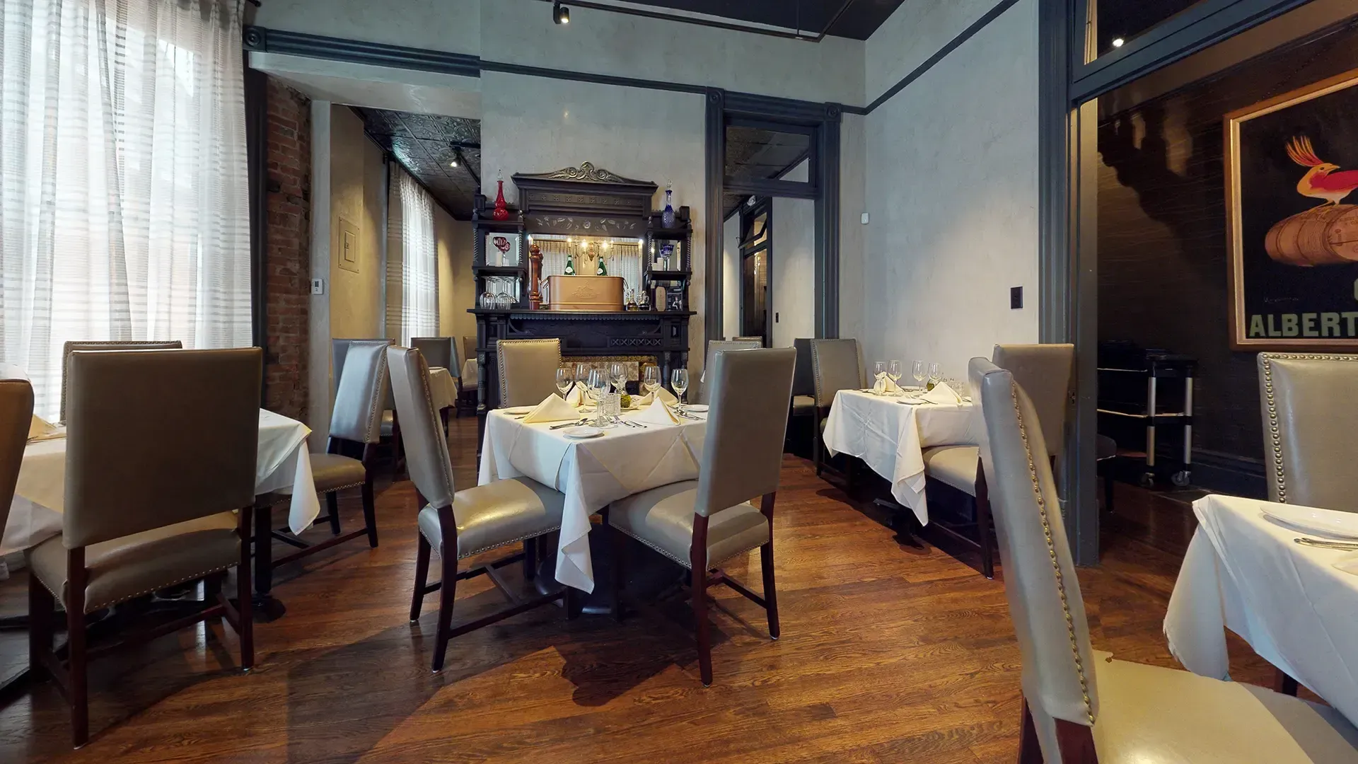 A restaurant with tables and chairs and a sign that says albert