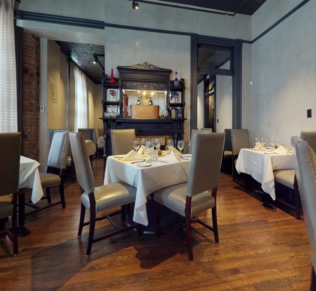 A restaurant with tables and chairs and a fireplace