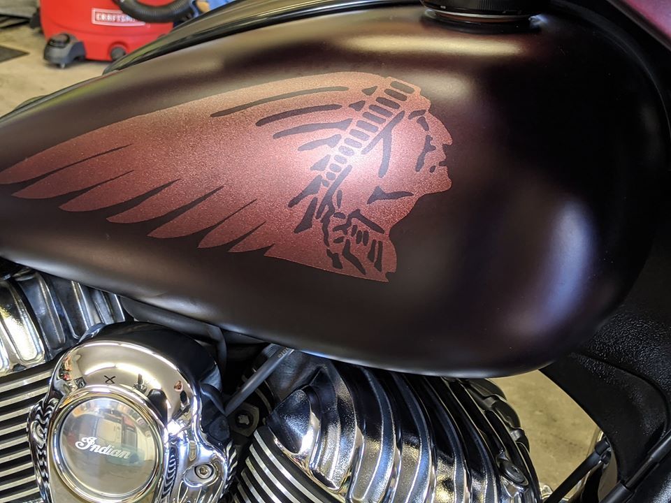 A motorcycle with a native american design on the tank