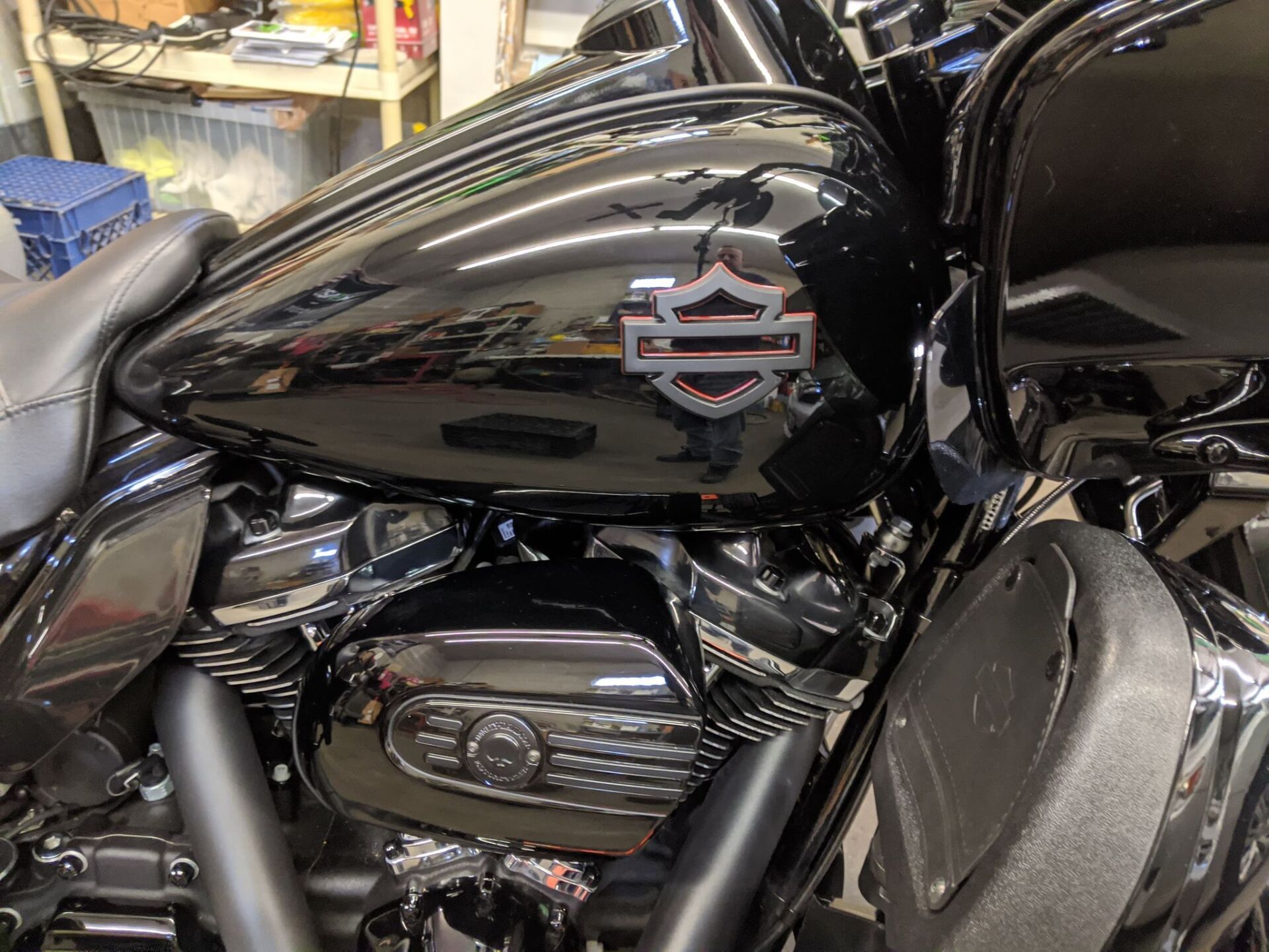 A black harley davidson motorcycle is parked in a garage.