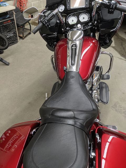 A red harley davidson motorcycle is parked in a garage