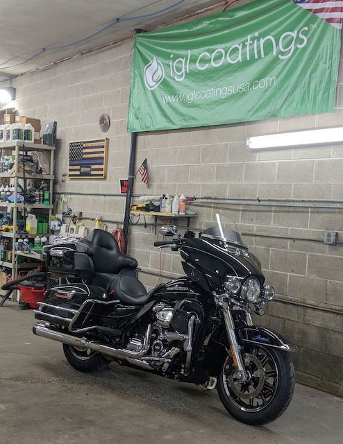 A black harley davidson motorcycle is parked in a garage