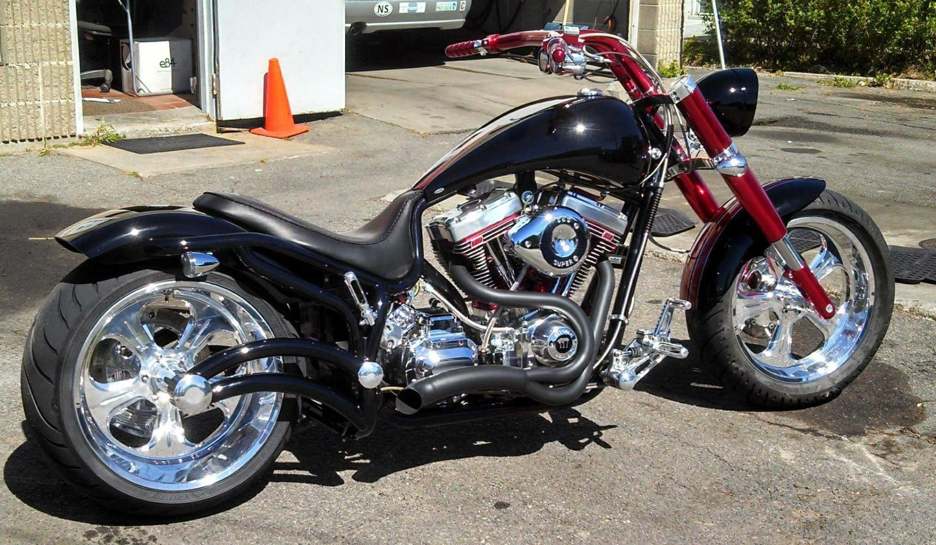 A black and red motorcycle is parked in a parking lot