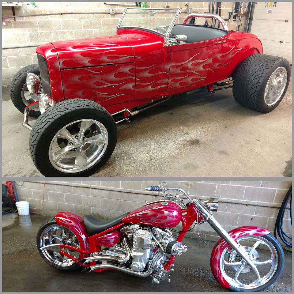 A red car and a red motorcycle are parked next to each other