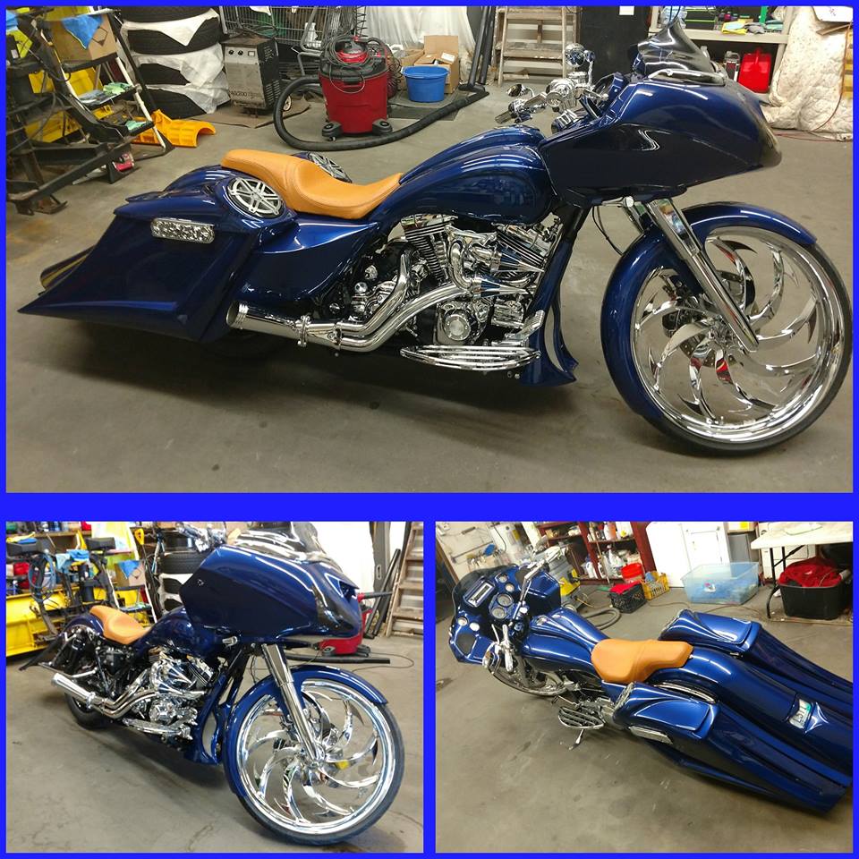 A blue harley davidson motorcycle is parked in a garage