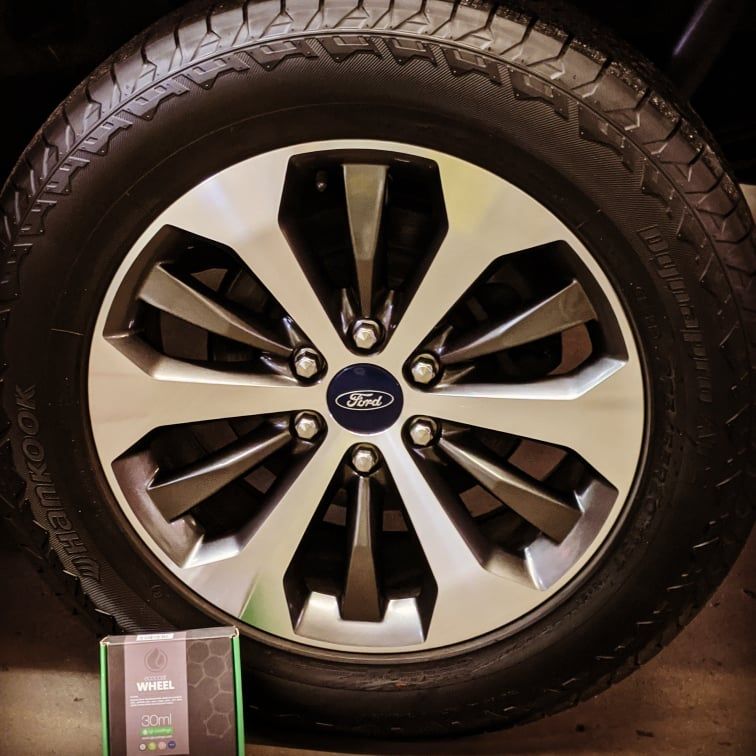 A close up of a ford wheel and tire