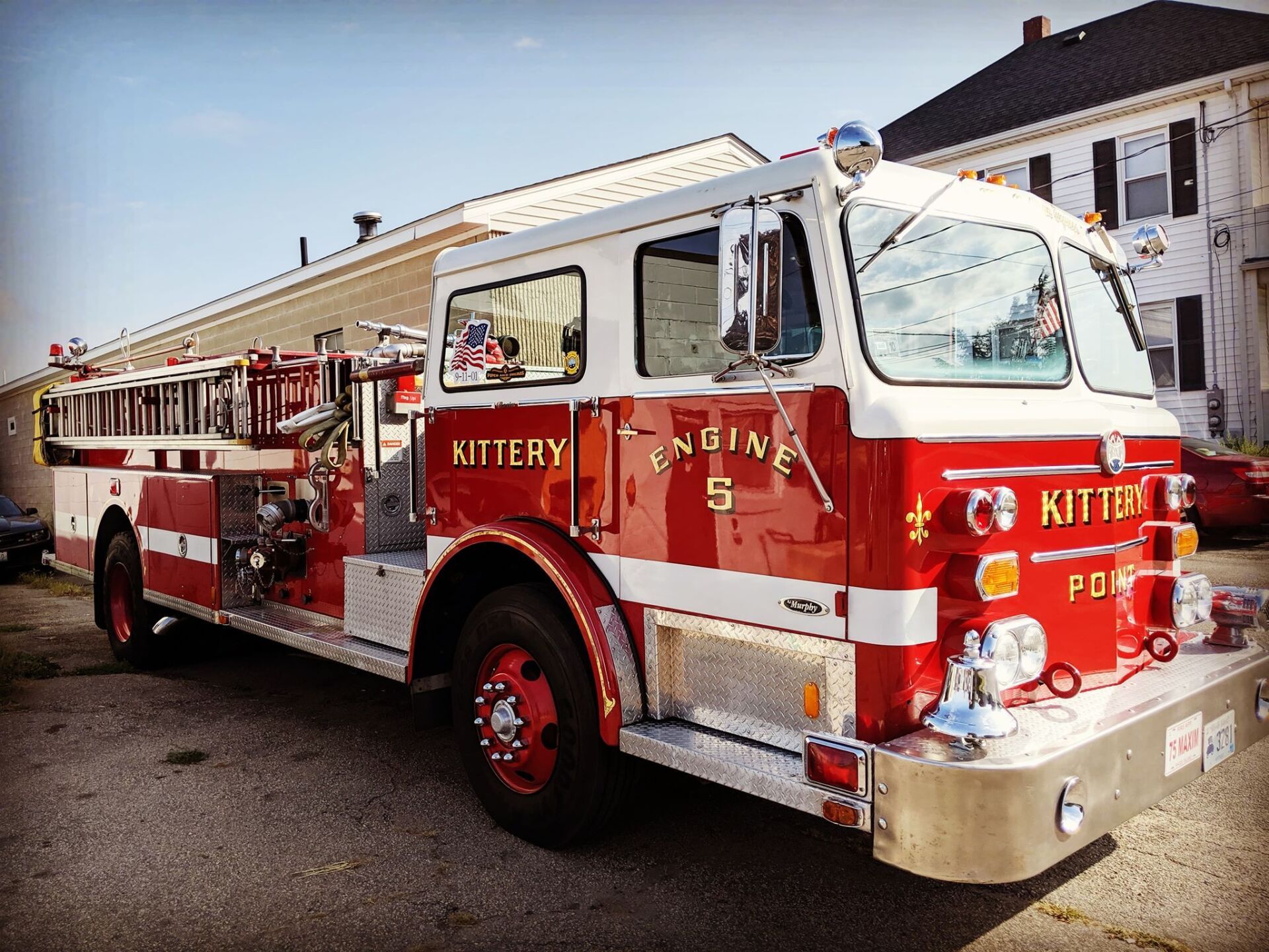 A red and white fire truck is parked in front of a building.