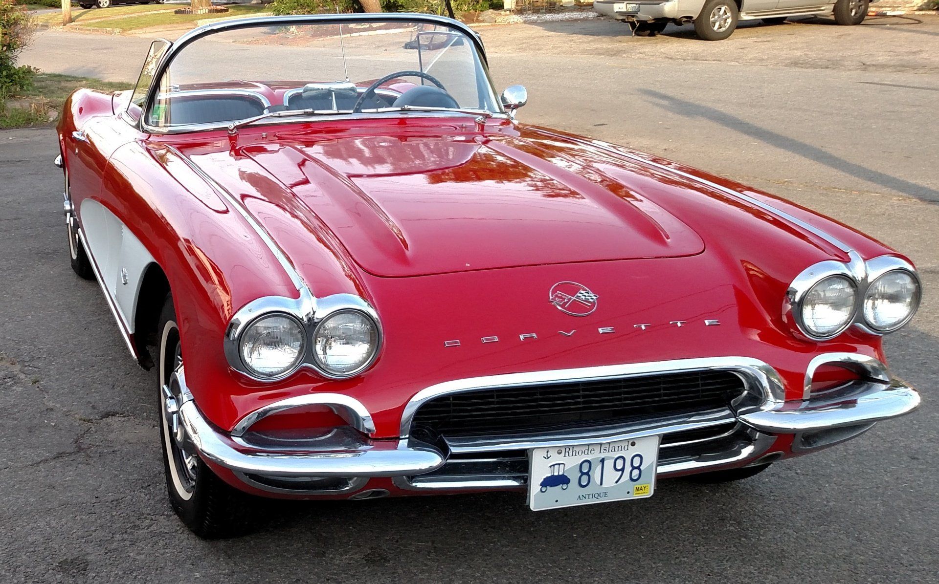 A red corvette with a license plate that says 0179