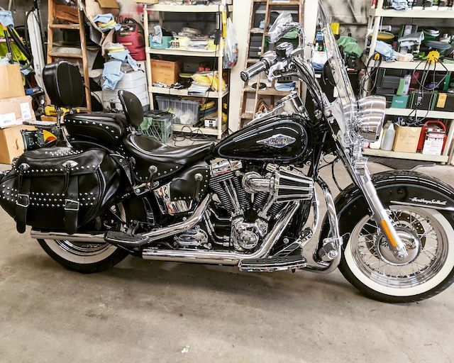 A black harley davidson motorcycle is parked in a garage.