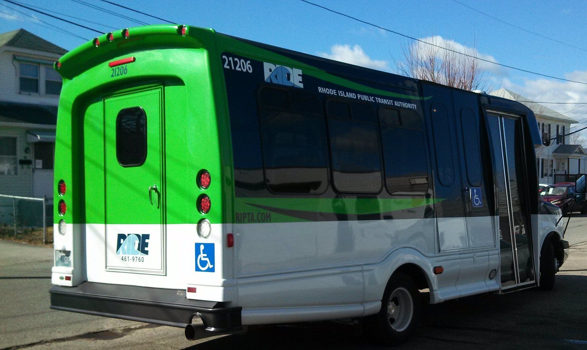 A green and white bus that says ride on the side