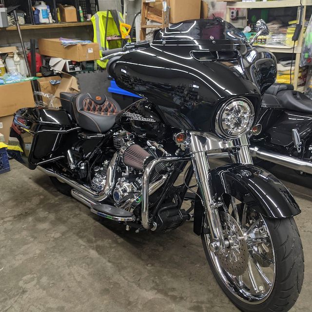 A black harley davidson motorcycle is parked in a garage