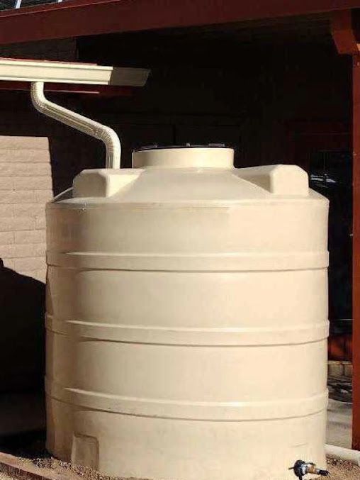 A large white water tank with a drain pipe attached to it