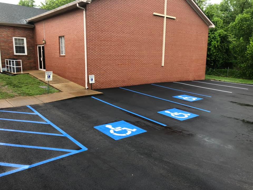 A brick building with a handicapped parking spot in front of it.