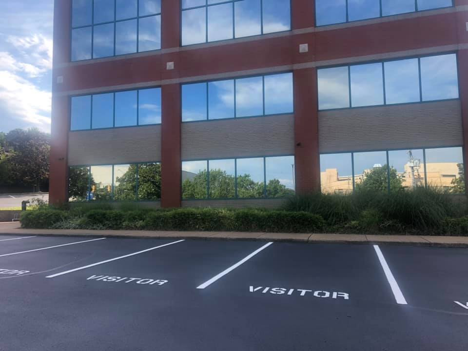 A large building with a parking lot in front of it.