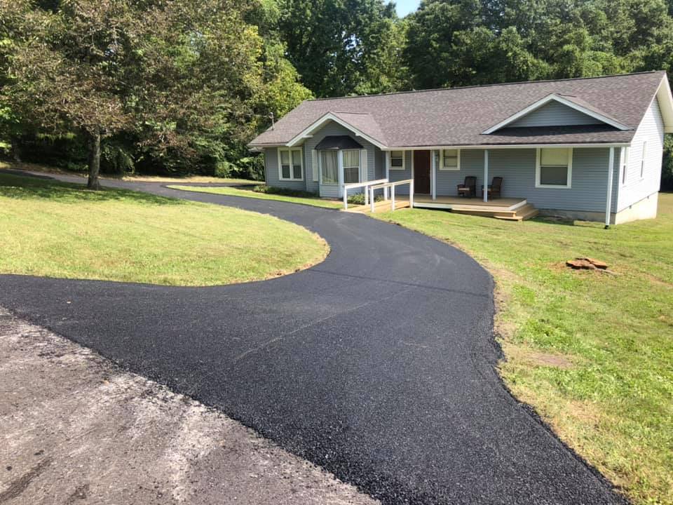 A house with a curved driveway leading to it