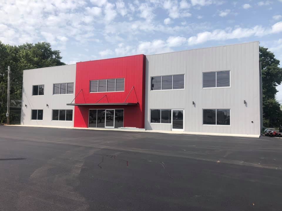 A large white and red building with a lot of windows
