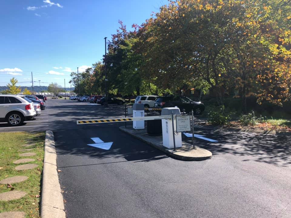 A parking lot with cars parked in it and a barrier
