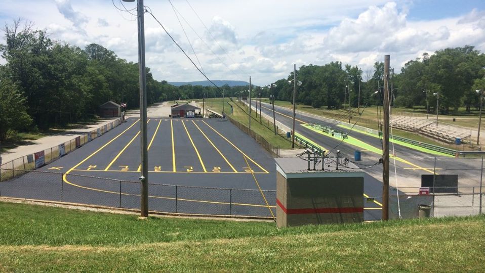 A view of a race track from the top of a hill.