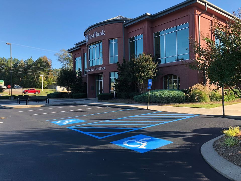 A large building with a handicapped parking spot in front of it.