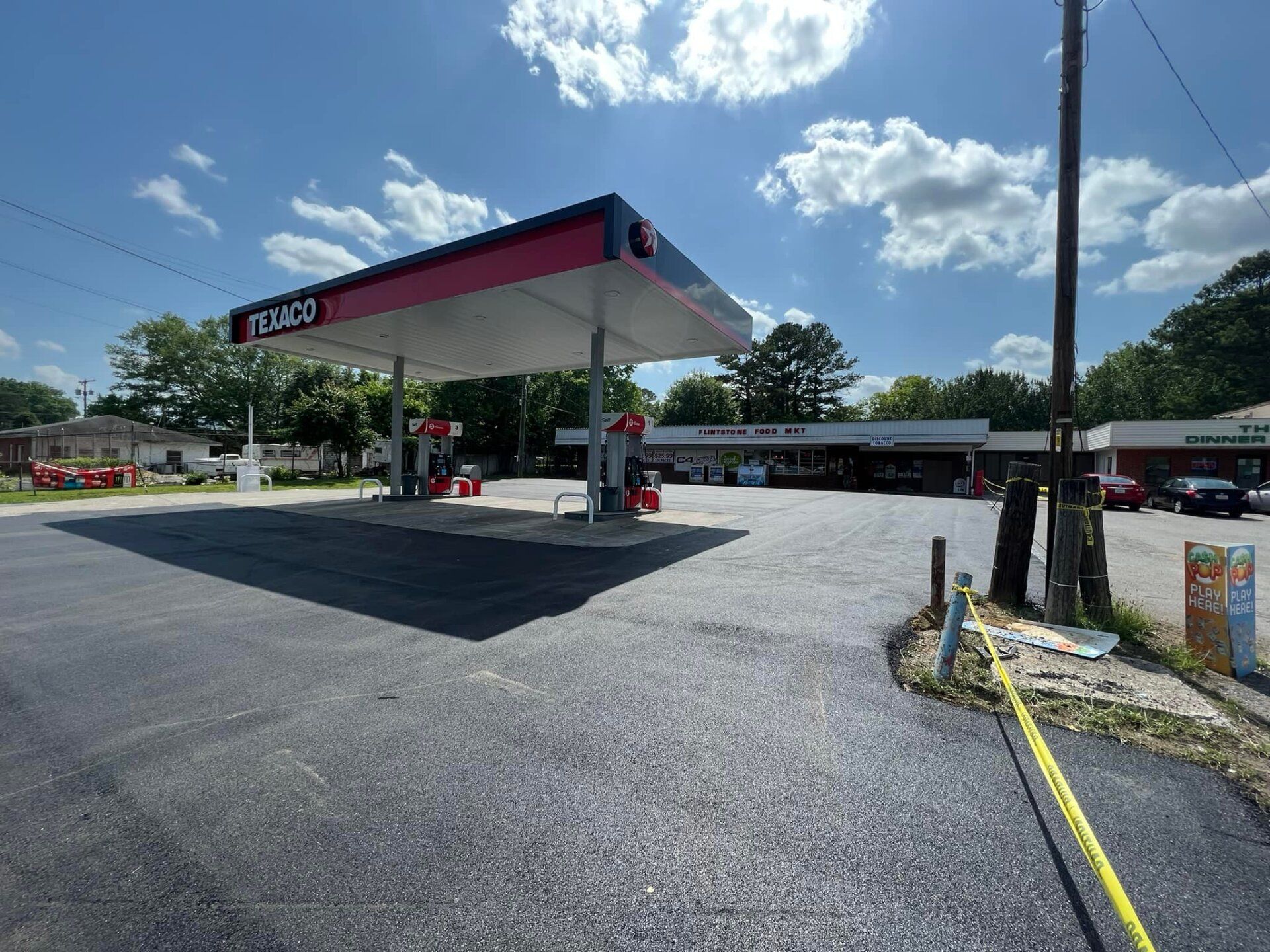 A redneck gas station with cars parked in front of it