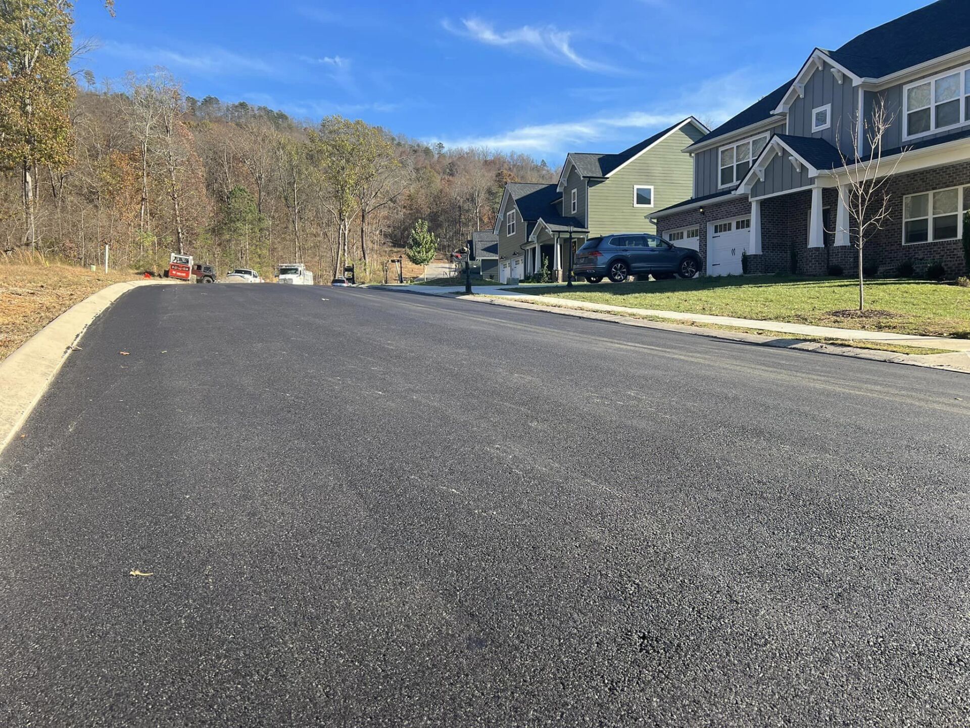 A row of houses are lined up on the side of a road.