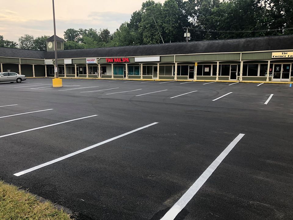 An empty parking lot in front of a shopping center