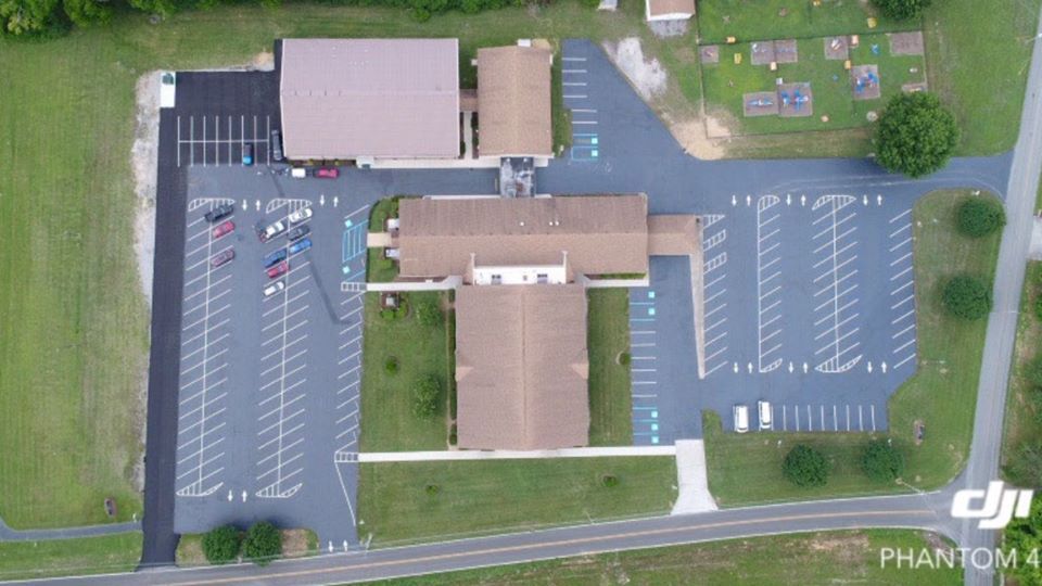 An aerial view of a church and parking lot.