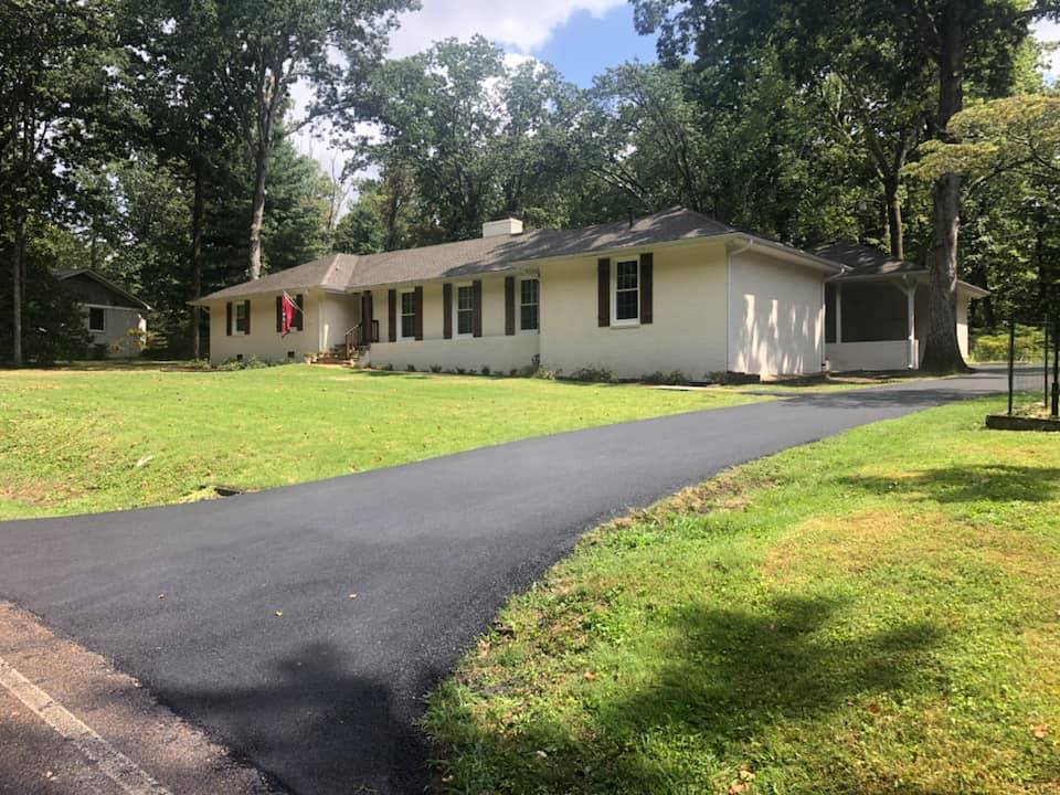 A white house with a driveway leading to it