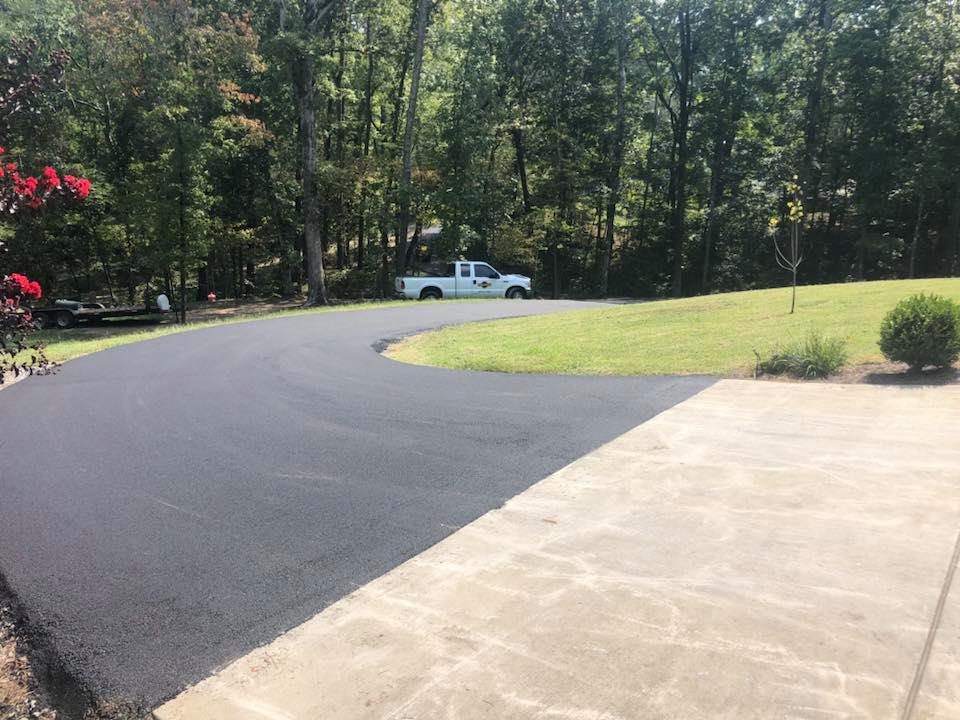 A white truck is driving down a curvy road.