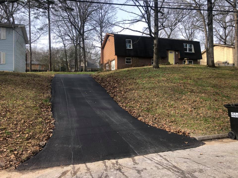 A driveway leading to a house on a hill.