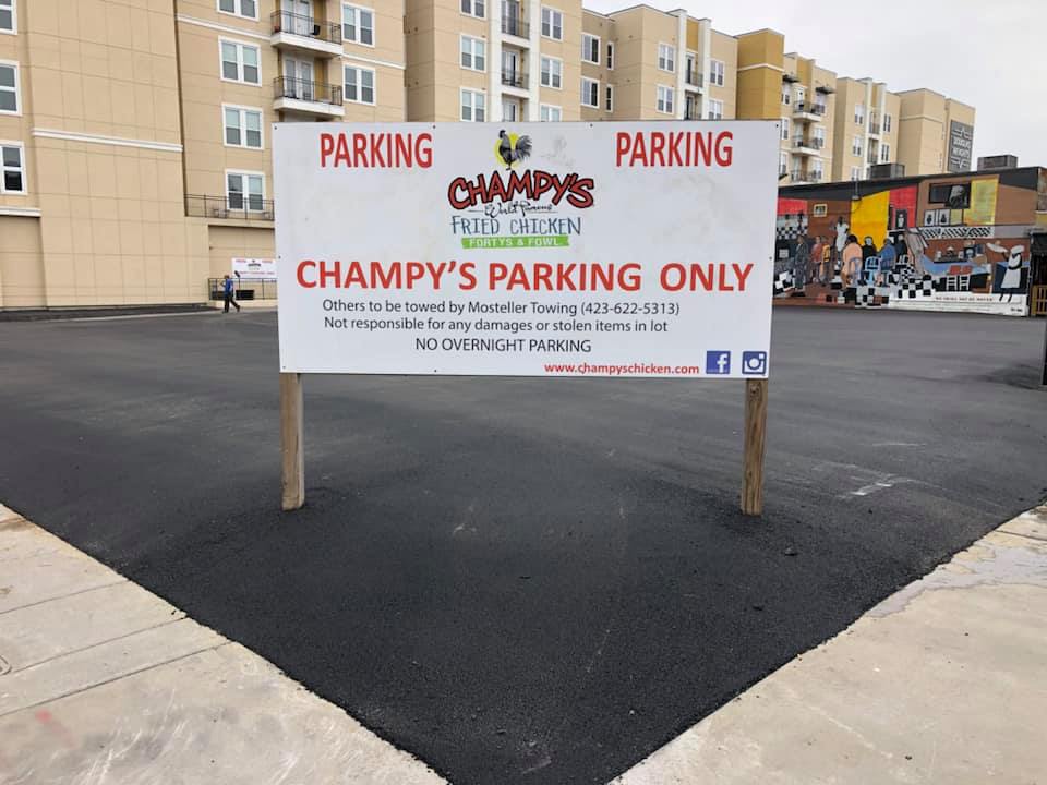 A parking sign that says champy 's parking only