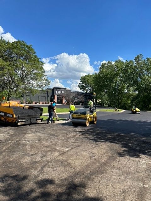 A group of construction workers are working on a road.