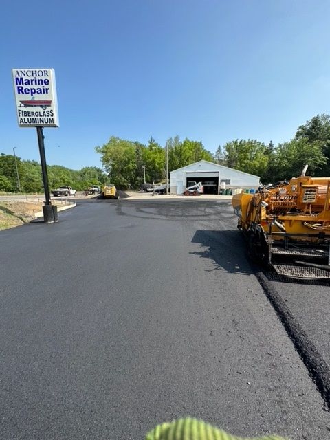 A group of construction workers are working on a road.