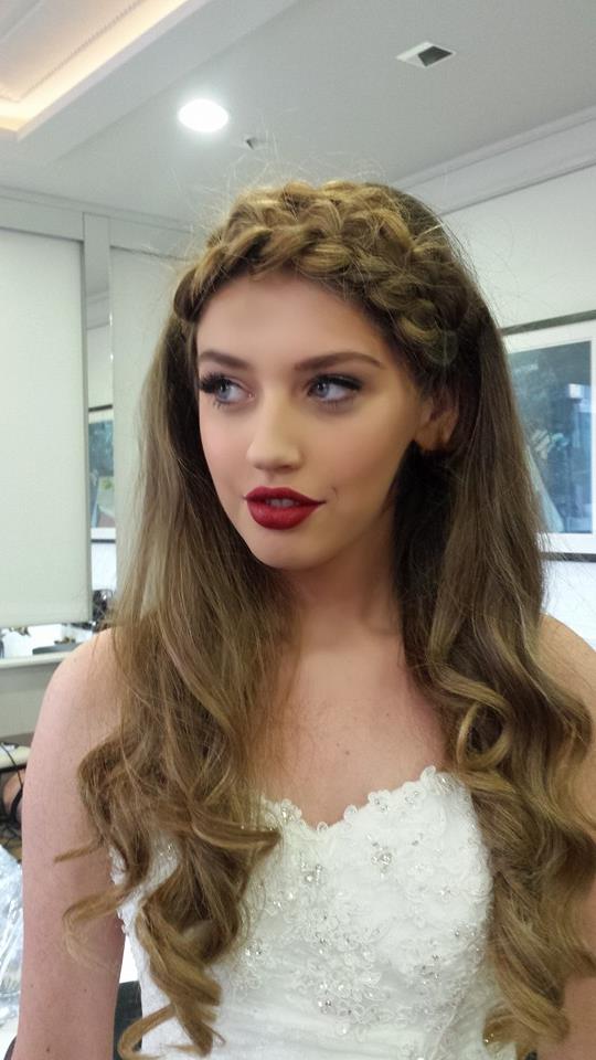 Bride on balcony surrounded by confetti
