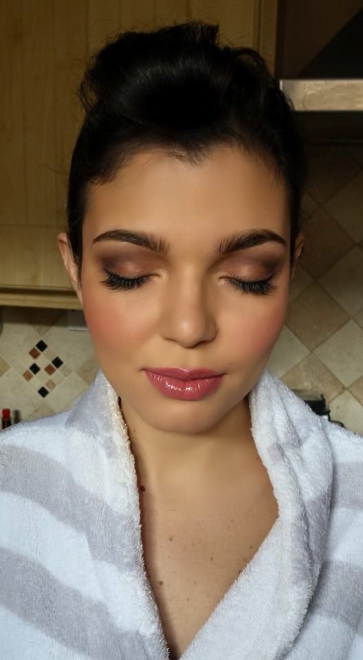 Woman in robe looking down to show eye make-up