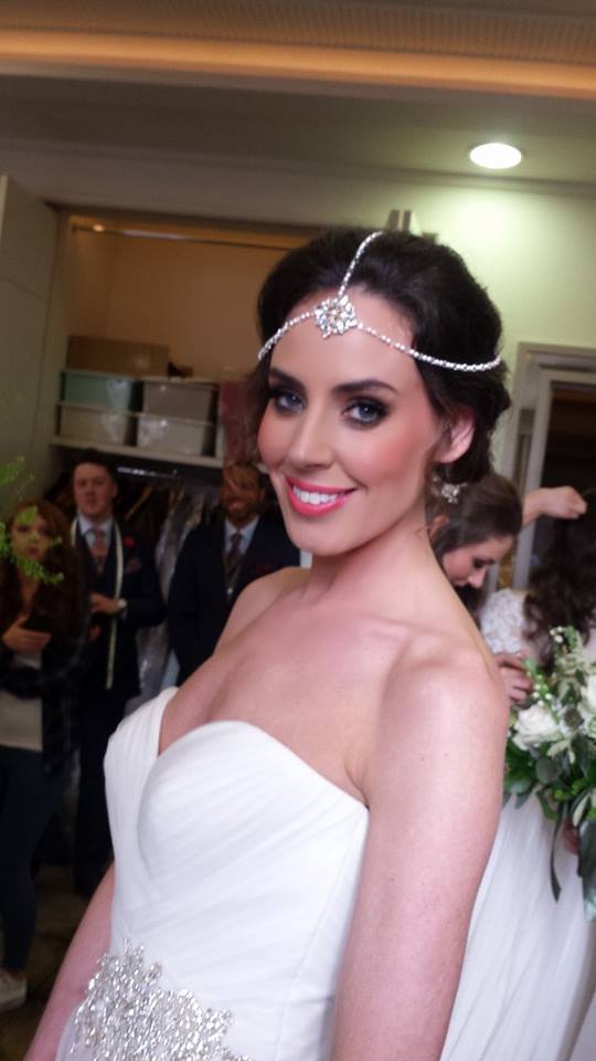 Bride with head piece smiling for camera