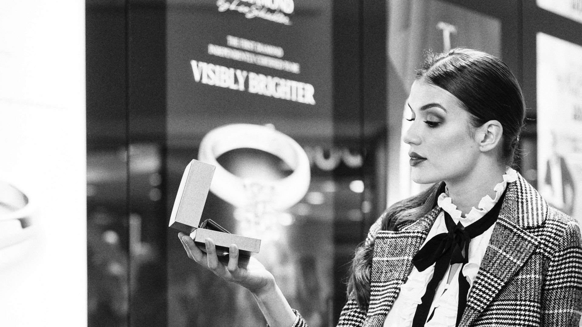 Black and white side view images of woman looking into box