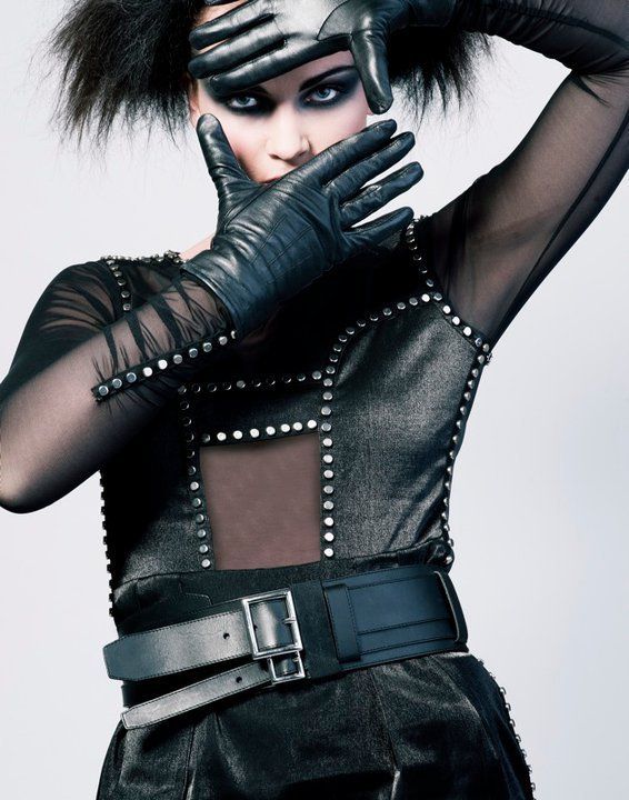 Woman with orange eye make-up and 80s style hair