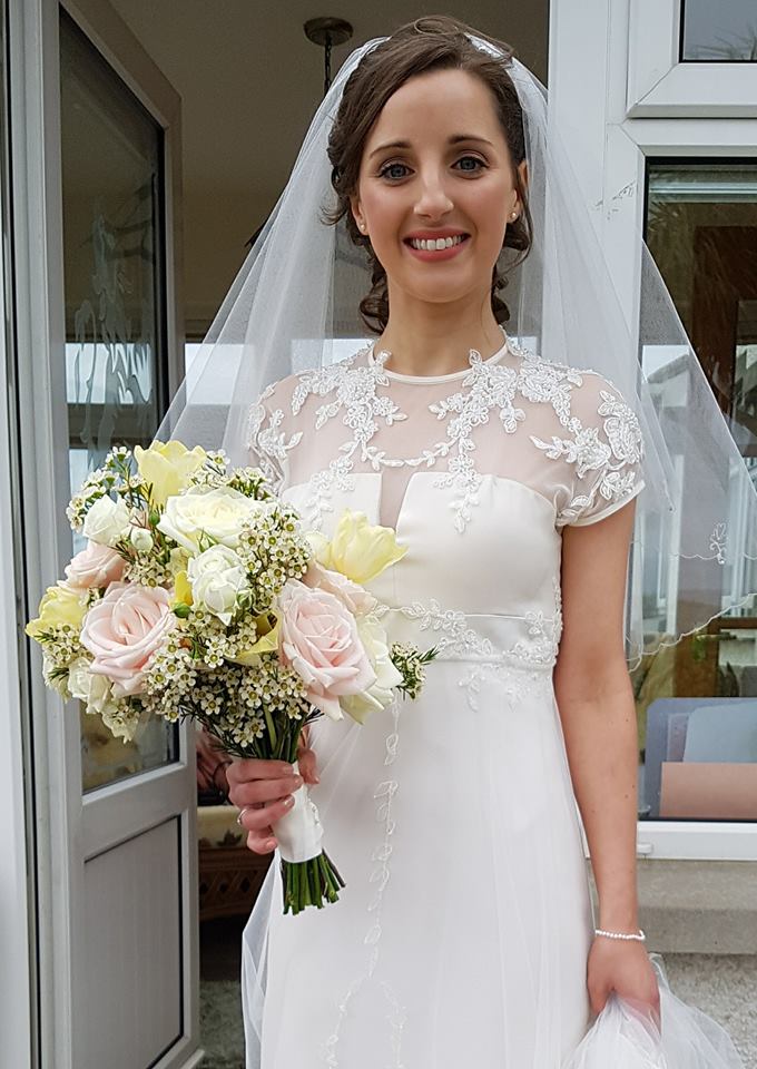 Bride smiling with flowers