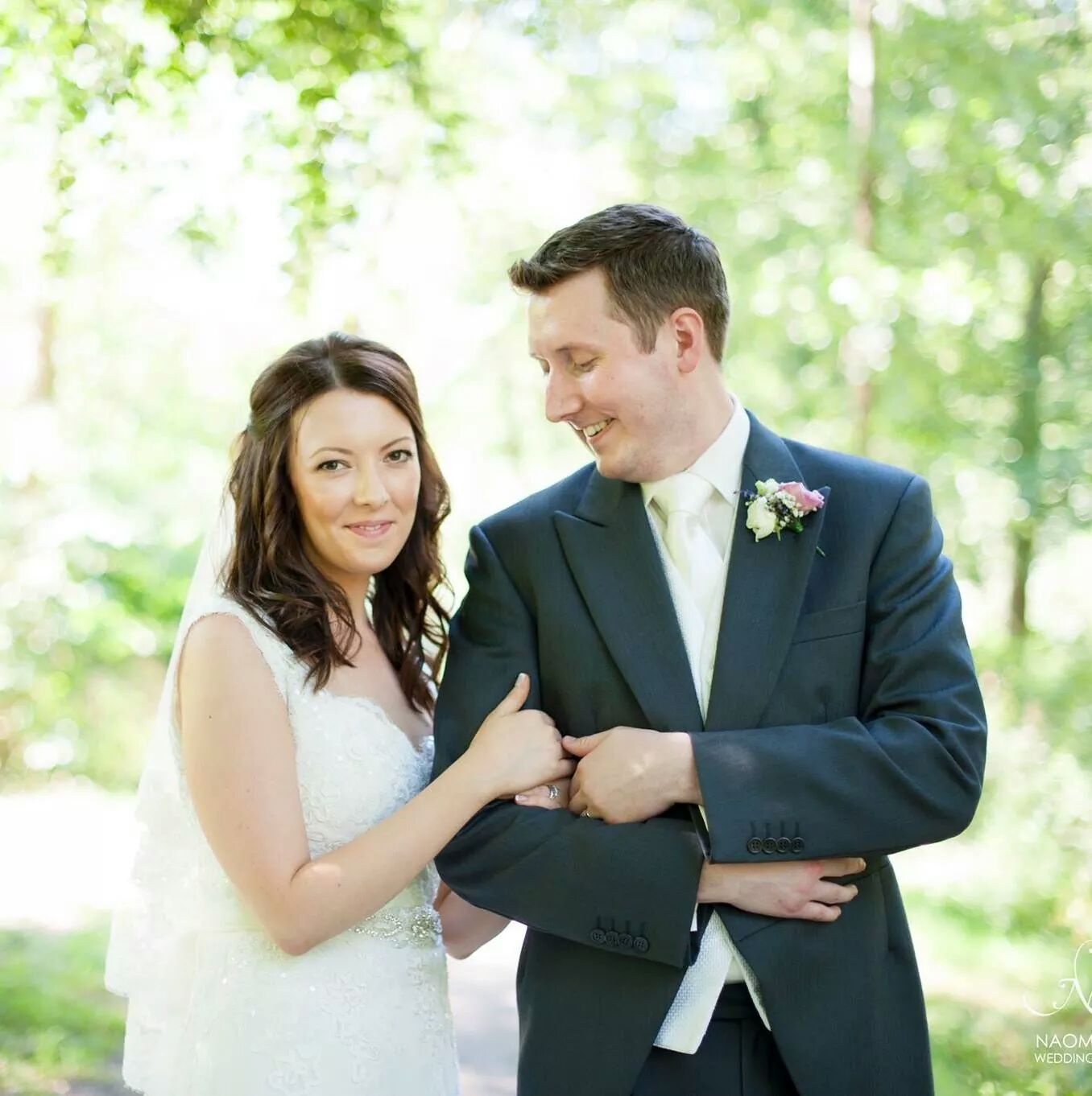 Bride and groom walking with linked arms