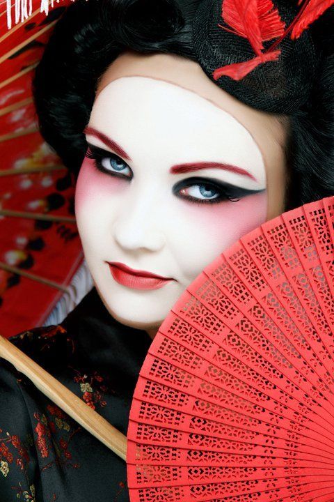 Woman dressed as geisha looking at camera