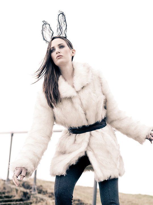 Woman with pink fluffy hoodie wearing rabbit ears