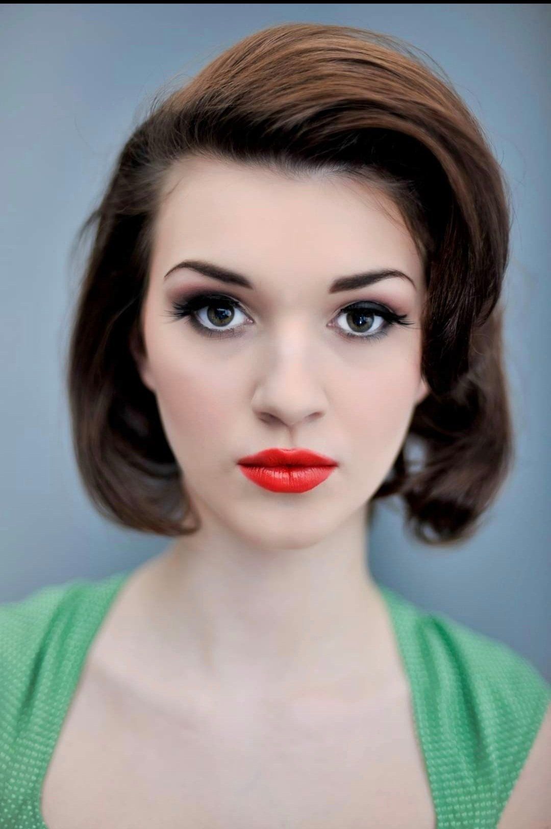 Close-up of woman with 60s hair and red lips pouting