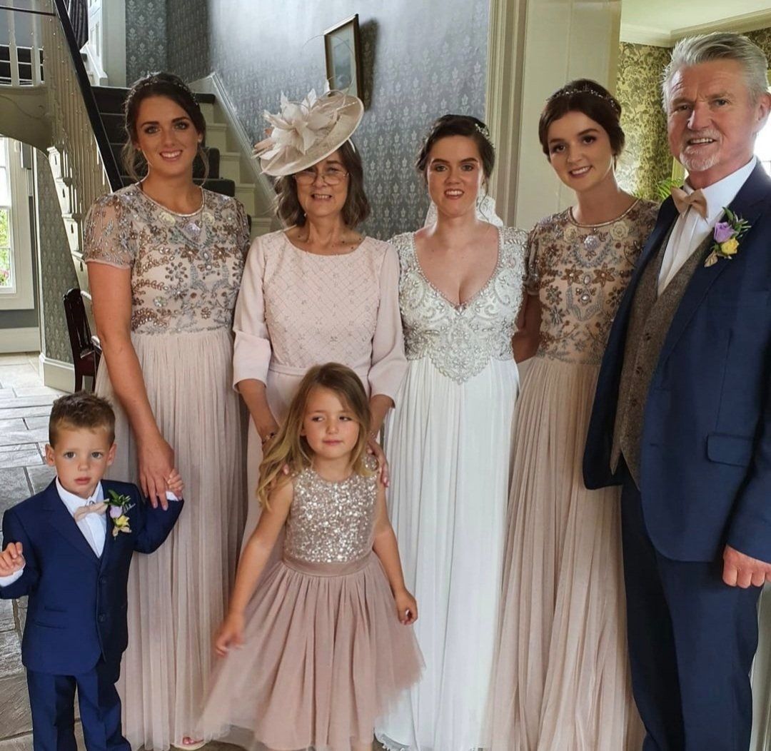 Bride and various wedding guests posing for camera