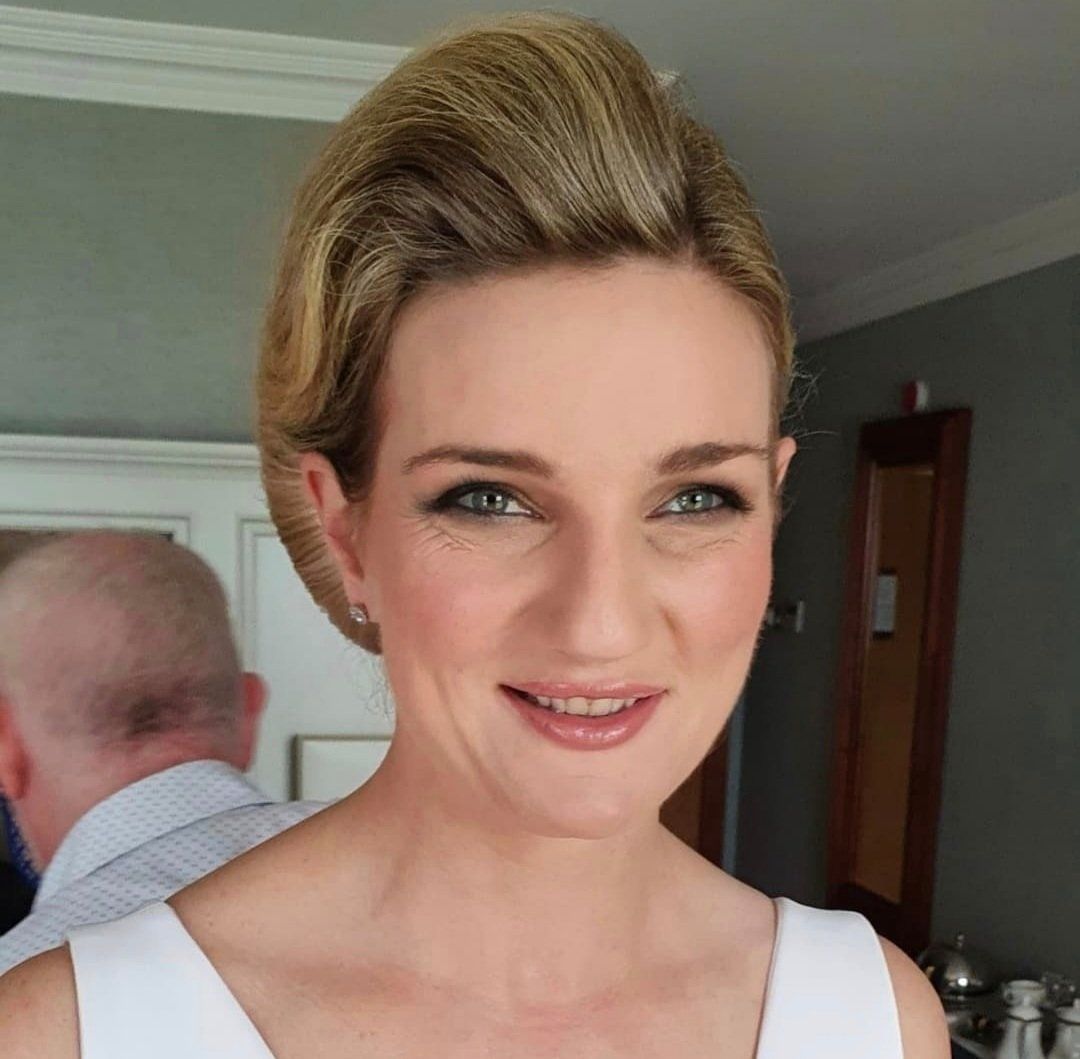 Bride with short hair smiling at camera