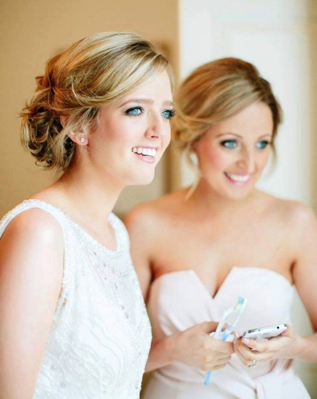 Two brides looking away from camera, smiling