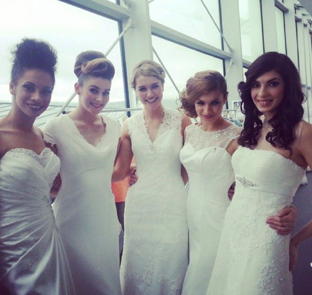 5 women wearing wedding dresses and posing